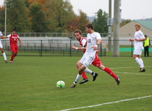 Ryan Dodds‘15 fights for possession of the ball 
against Boston University.