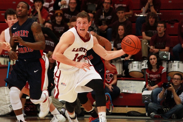 Sophomore guard Bryce Scott pushes the fast break against Robert Morris in the home opener on Tuesday. 