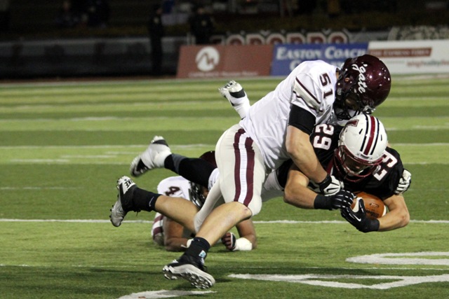 Running back Ross Scheuerman ‘15 is tackled in the second half against Colgate on Saturday. 