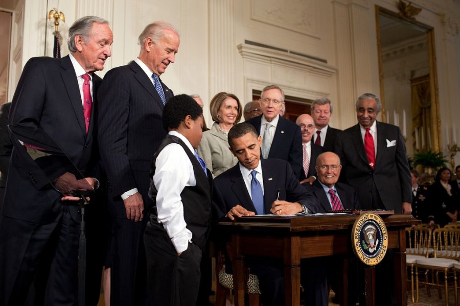President Obama signs the Patient Protection and Affordable Care Act in March 2010.