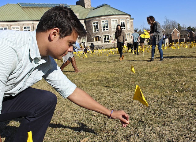 Eddie Andujar ‘15 plants flag on the Quad as part of HSL’s campaign to raise awareness for
Migrant Deaths along the US- Mexico Border. [Photo by Christina Shaman ‘16]