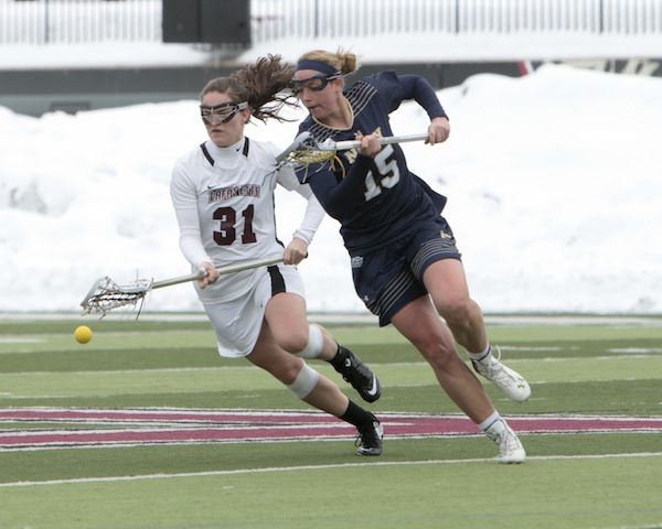 Kristen Wilhelmsen battles for a loose ball against their opponent, Navy.  [Photo courtesy of Athletic Commubnications]