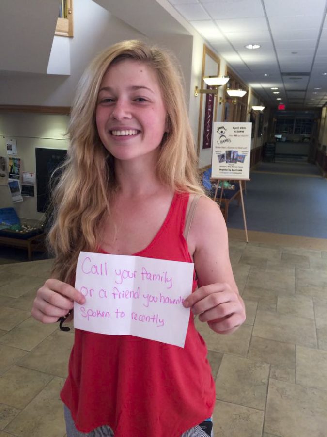 Sarah Pavlini ‘16 pulls a suggestion for a random act of kindness from a raffle. [Photo courtesy of Monica Meng ‘18]