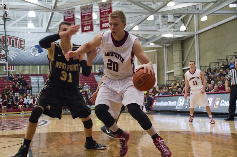 Dan Trist dribbles on the baseline past an Army defender. [Photo Courtesy of Athletic Communications]