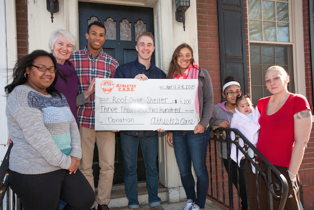 Athletes+C.A.R.E.+presenting+their+donation+to+Roofover+Shelter.%0A%5BPhoto+by+Clay+Wegrzynowicz+%E2%80%9818%5D
