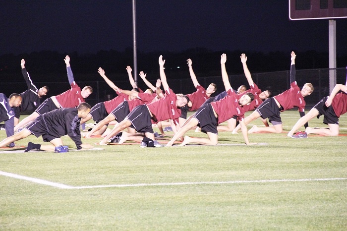 Soccer team practices yoga on Metzgar Field.  [Photo by Christie Behot ‘16]