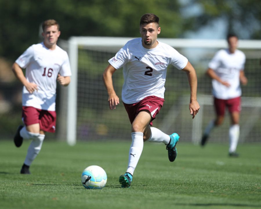 Ben Marks 17 dribbles the ball. (Courtesy of Athletic Communications)