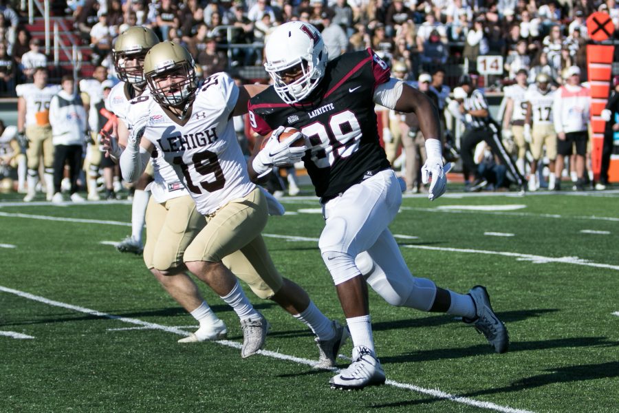 Photo by Hana Isihara 17. Junior TE Dylan Wadsworth runs with the ball next to Lehigh players.