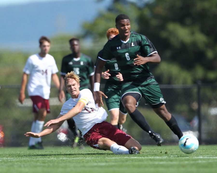 Ryan Egan '17 makes a slide tackle. (Courtesy of Athletic Communications)