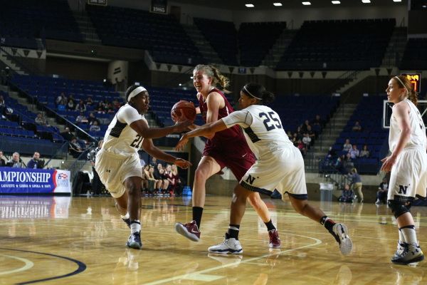 Harriet Ottewill-Soulsby 17 drives to the basket between defenders (Photo courtesy of Athletic Communications)