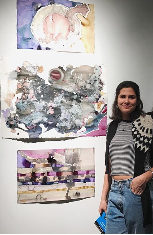 Lia Embil 17 poses with a triptych from her project (Photo courtesy of Mailinda Hoxha 19).