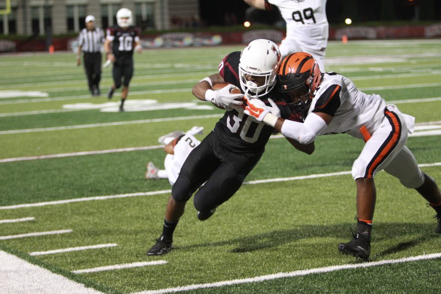 Senior RB DeSean Brown being pushed out of bounds by a Princeton defenseman (Photo Courtesy of Athletic Communications)