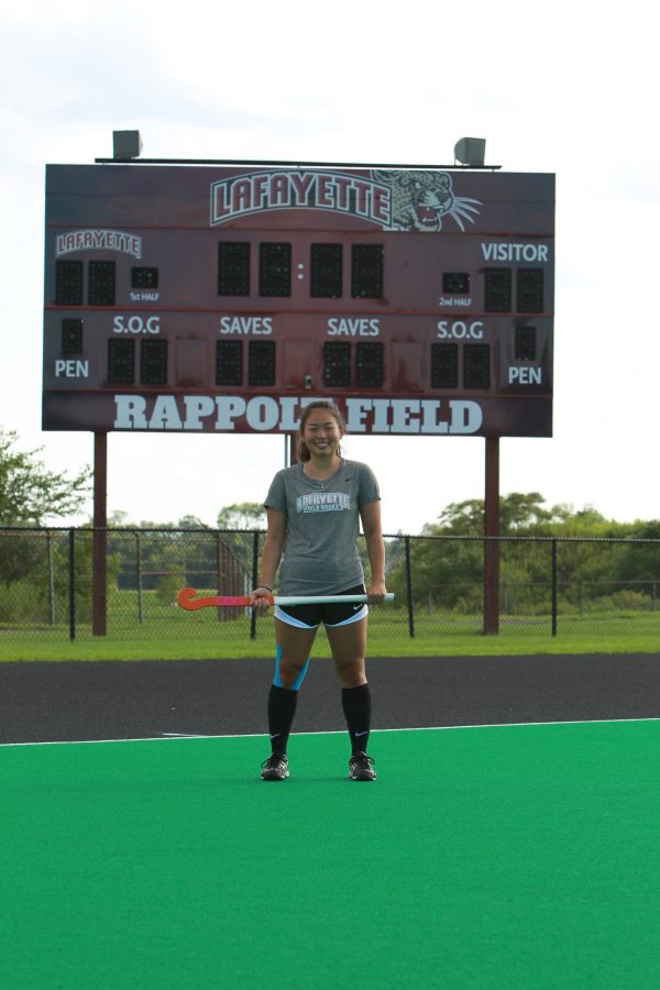 Sarah Park poses with her field hockey stick at Rappolt Field. Courtesy of Athletic Communications.