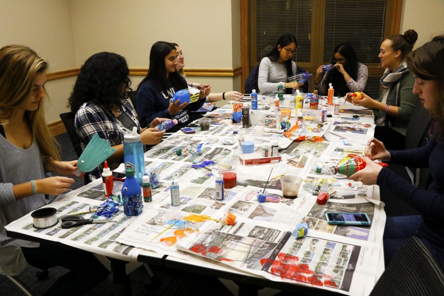 Students use recycled bottles to create colorful fish to be hung in Farinon. (Photo by Jess Furtado 19)