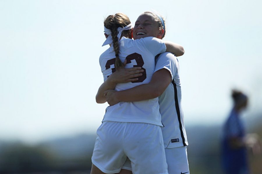 Freshman Krista Kissel and junior Alex Stanford share a celebratory embrace. Courtesy of Athletic Communications