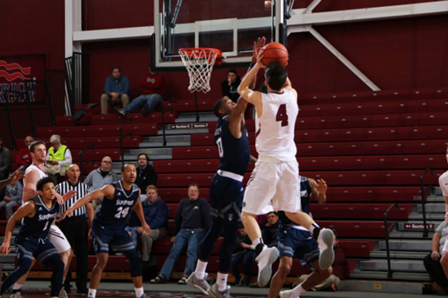 Senior guard Eric Stafford jumps up for a shot against Saint Peter's. (Photo Courtesy of Athletic Communications)