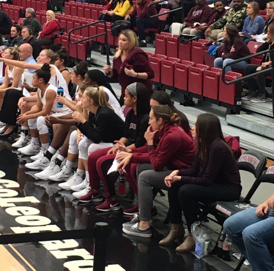 Sports psychologist Julie Amato sits on the bench during a womens basketball game. (Photo courtesy of Julie Amato)