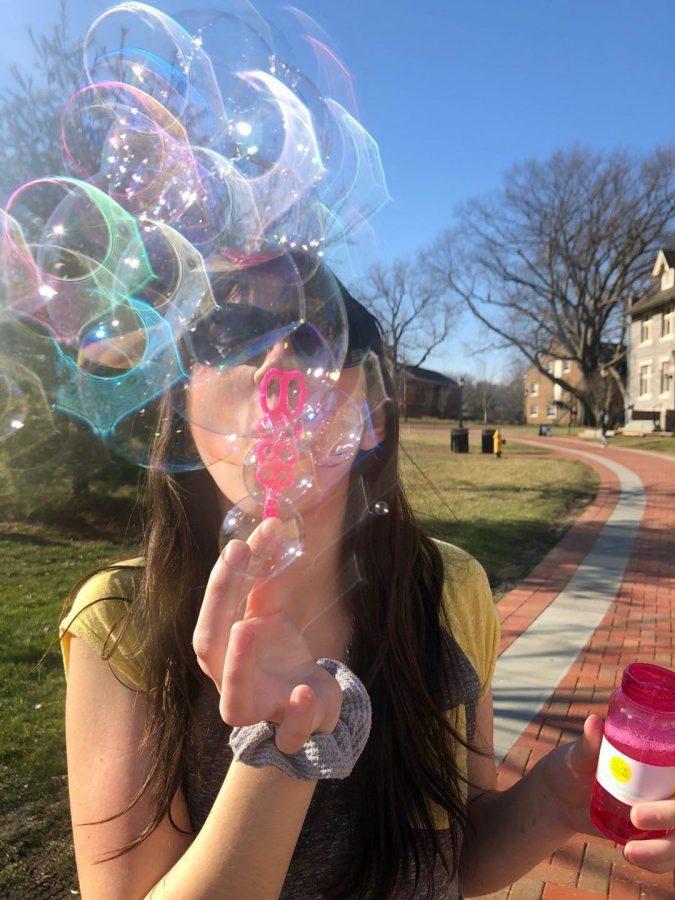 Emma Hartman 23 blows some bubbles on the quad during Mondays festivities hosted by Lafayette Happiness Project last week. (Photo courtesy of Presley Anderson 23)