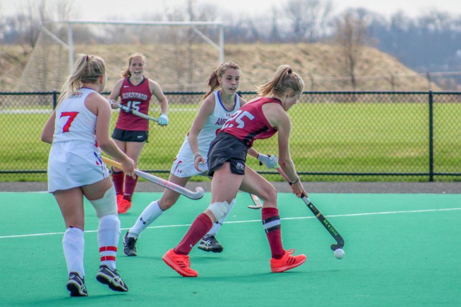 Senior midfielder Anna Steps fends off two American players last weekend. (Photo courtesy of Athletic Communications)