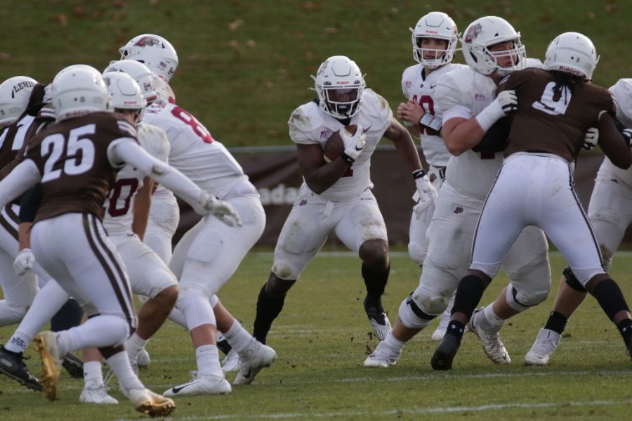 Junior running back Jaden Sutton (#1) (pictured) hits the hole during his 70-yard rushing performance during 157th rivalry game. (Photo courtesy of GoLeopards.com)