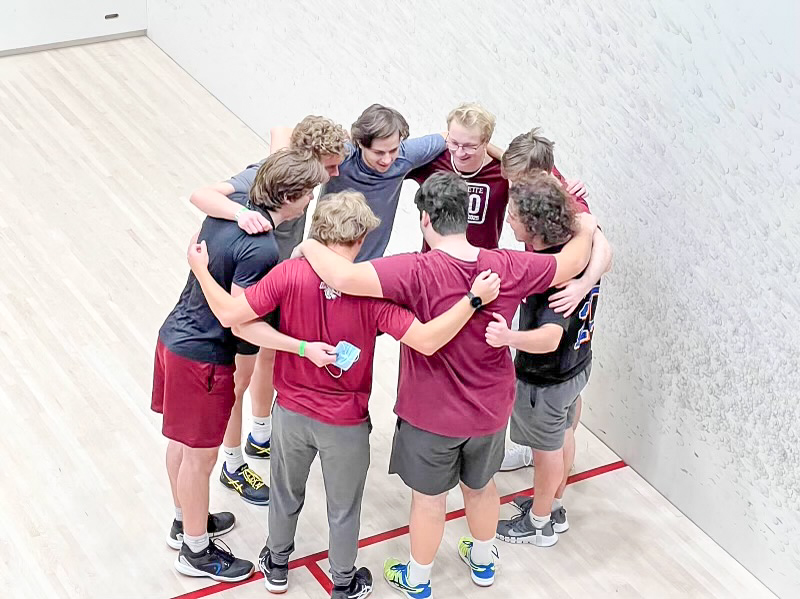 The club squash team huddles together before a match at the CSA National Collegiate Club Team Championship. (Photo courtesy of Jack Burton 22)