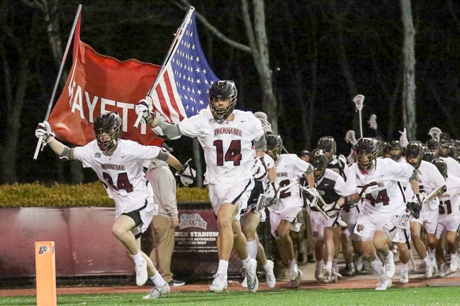 Sophomores+Peter+Lehman+and+John+Mathes+lead+the+mens+lacrosse+team+on+to+the+field+right+before+their+Patriot+League+match+up+against+the+Colgate+Raiders.+%28Photo+courtesy+of+GoLeopards%29+