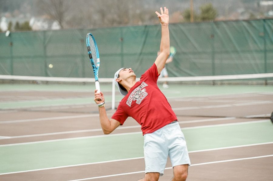 Arman Ganchi '25 mid-serve during his court one victory over Loyola. This domination led to his receiving the Patriot League Player of the Week. (Photo Courtesy of Goleopards.com)