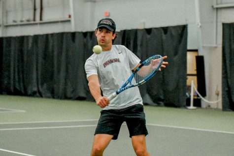 Sophomore Davus Esslinger fires a backhand during his singles match against Holy Cross last week. 
(Photo courtesy of GoLeopards)