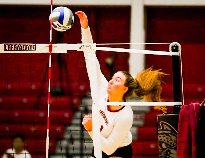 Sophomore outside hitter Abby Nieporte spikes a ball for a point during the Leopards victory over Manhattan College last weekend. (Photo by Rick Smith for GoLeopards)