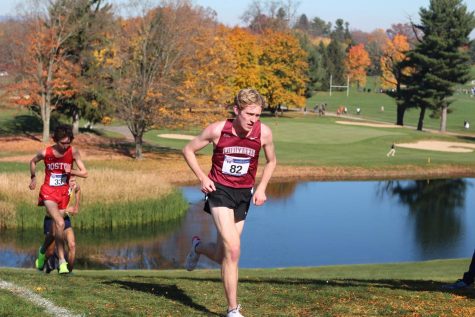 Senior Bobby Oehrlein crests the steepest hill at the 2022 Patriot League Cross Country Championships, where he finished 11th. (Photo courtesy of Nina Koobatian 23)