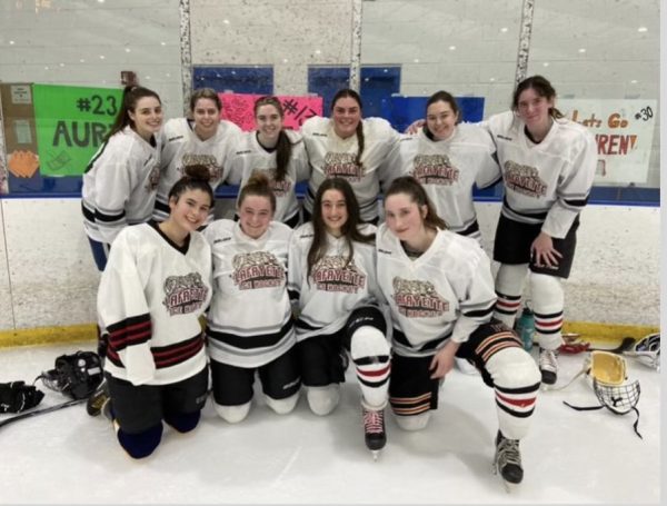 The womens club ice hockey team poses on the ice. (Photo courtesy of Lily Hooghuis 26)