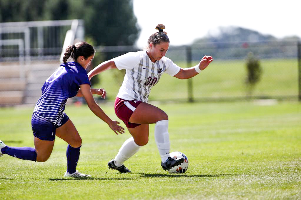 Senior forward Sara Oswald dribbles past a defender. (Photo courtesy of GoLeopards)