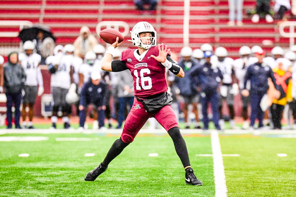 Sophomore quarterback Dean DeNobile drops back to pass during the win against Monmouth. (Photo by Hannah Ally for GoLeopards)