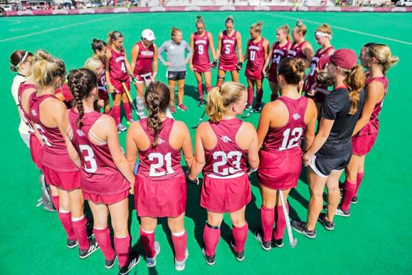 The field hockey team gathers for a huddle at Rappolt Field. (Photo by Rick Smith for GoLeopards)