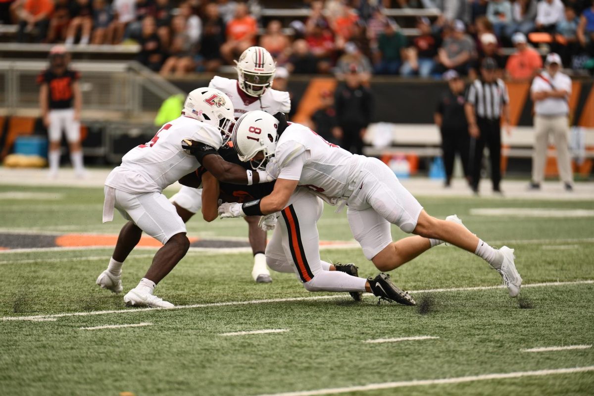 The Leopards combine for a tackle against Princeton. (Photo by Hannah Ally for GoLeopards)