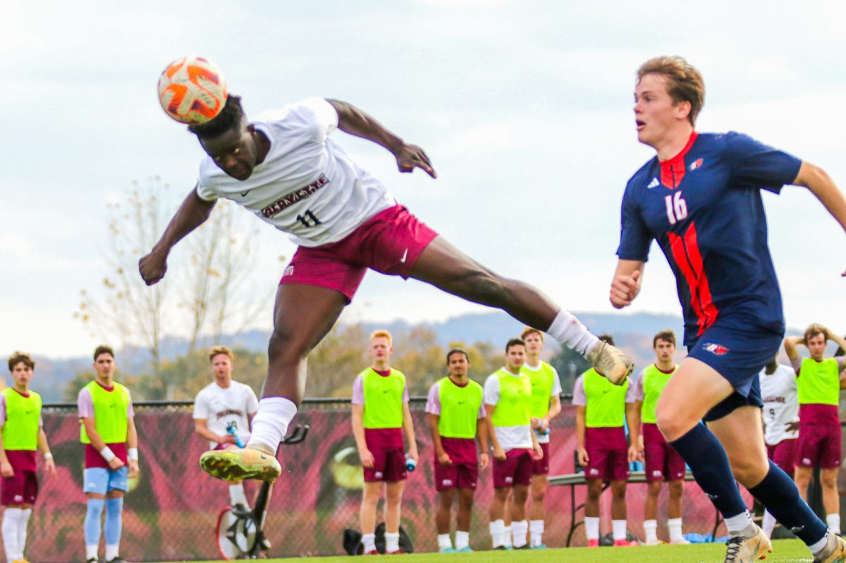 Junior forward Andrey MacIntyre jumps up for a header against Bucknell. (Photo by Rick Smith for GoLeopards)