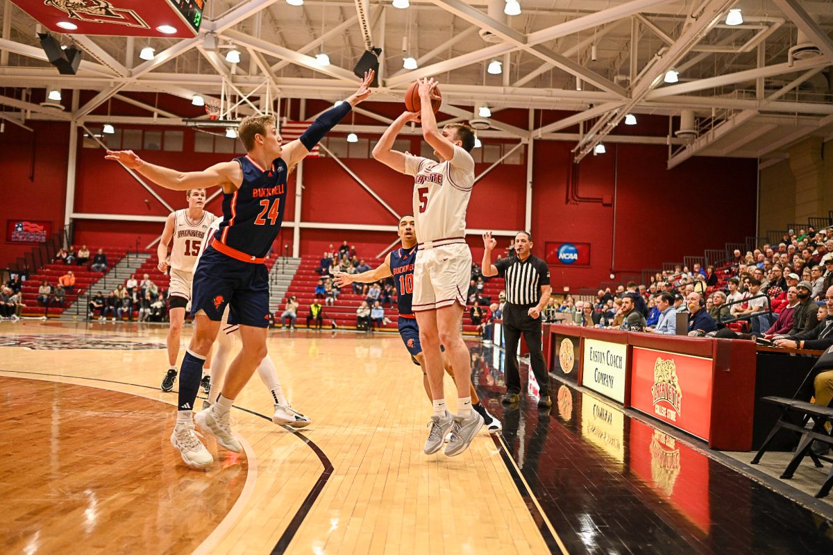 Junior guard Eric Sondberg takes a shot over a Bucknell defender. (Photo by George Varkanis for GoLeopards)