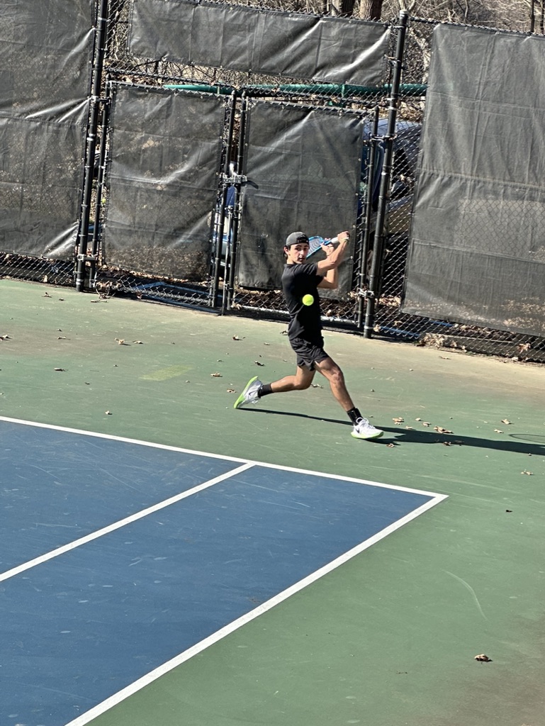 Junior Arman Ganchi returns a backhand during the match against Le Moyne College.