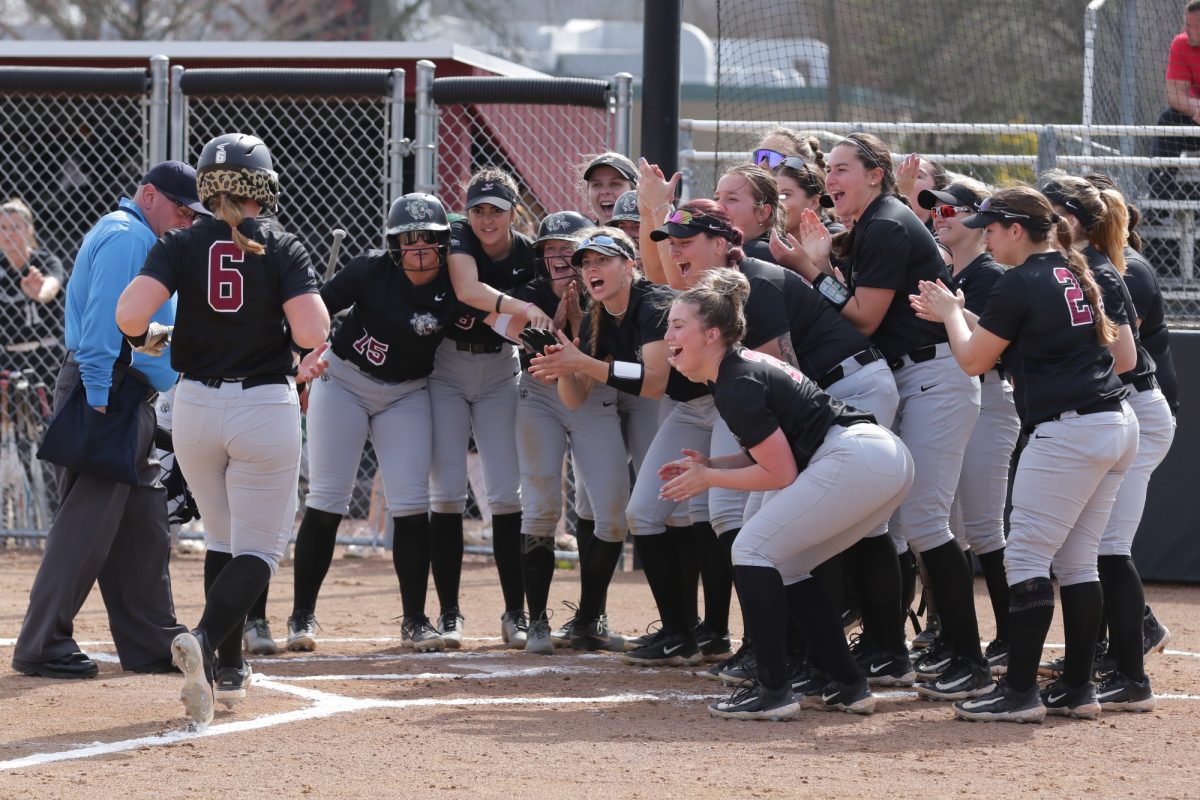 The+softball+team+celebrates+during+the+game+against+Le+Moyne+on+March+13.+%28Photo+by+Rick+Smith+for+GoLeopards%29