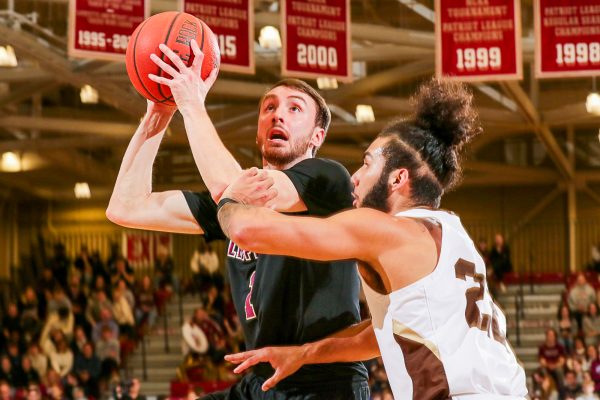 Junior guard Luka Savicevic shoots over a Lehigh defender during the Leopards loss. (Photo by Rick Smith for GoLeopards) 