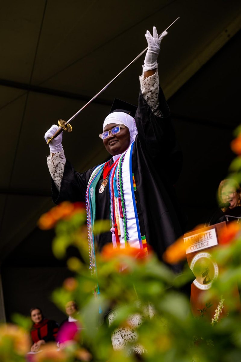 Last years Pepper Prize winner, Fatimata Cham 23, presents the sword at the 2023 commencement ceremony. (Photo courtesy of Lafayette College Flickr)