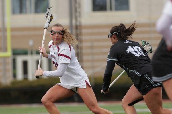 Junior attacker Sara Rogers evades a Loyola Maryland defender on April 6. (Photo by Rick Smith for GoLeopards)