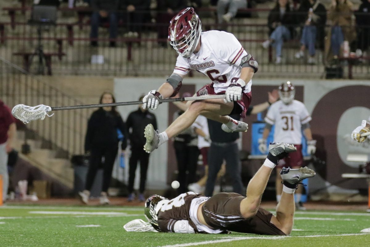 Tommy McGee hops over an opposing player. (Photo by Rick Smith for GoLeopards)