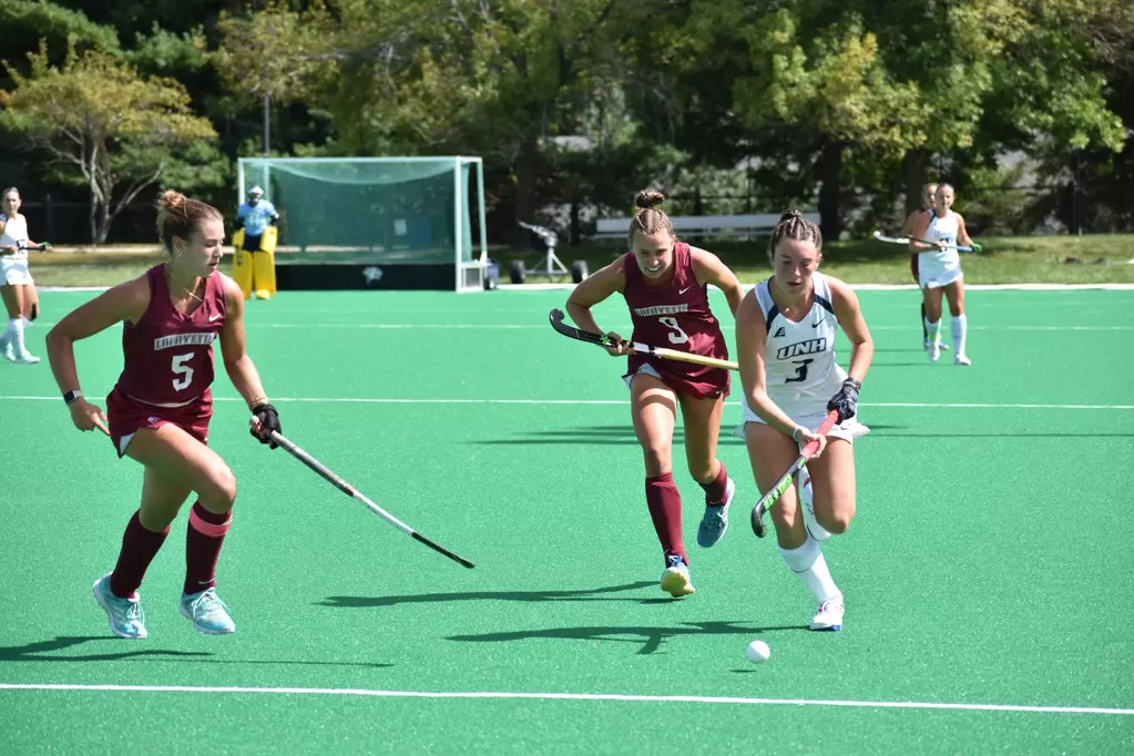 Junior defender Makenzie Switzer and senior midfielder Laine Delmotte try to keep up with a New Hampshire player. (Photo courtesy of University of New Hampshire Athletics)