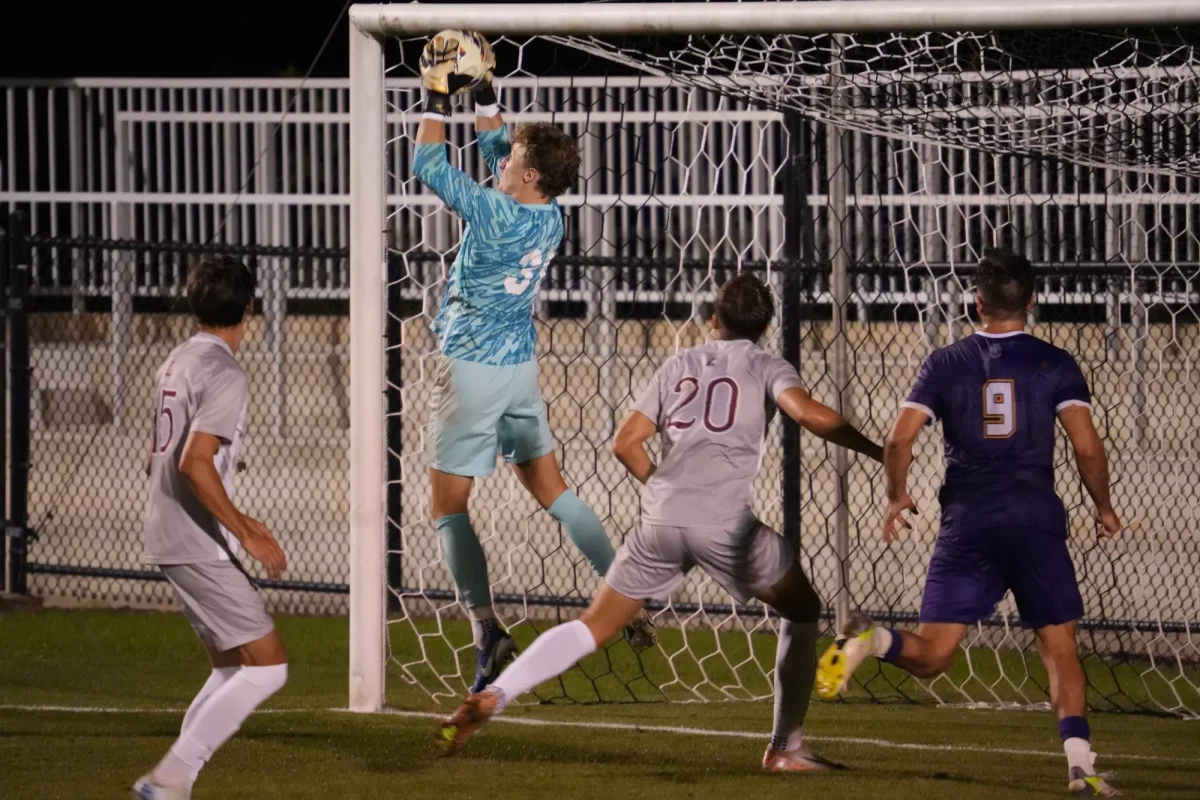 Junior goalkeeper Eric Axtman jumps for a ball in front of the goal in Tuesday's win against Albany. (Photo courtesy of GoLeopards)