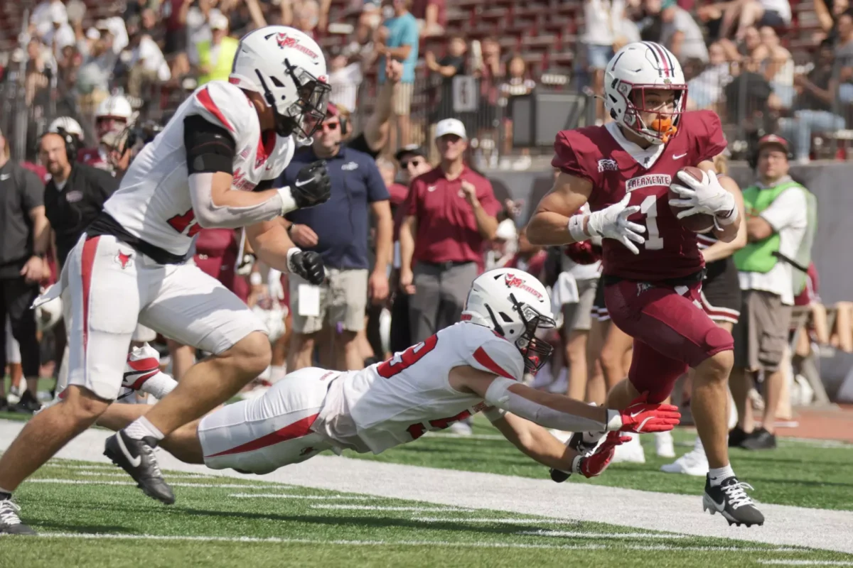 Junior wide receiver Elijah Steward evades a tackle against Marist on Saturday. (Photo by Rick Smith for GoLeopards)