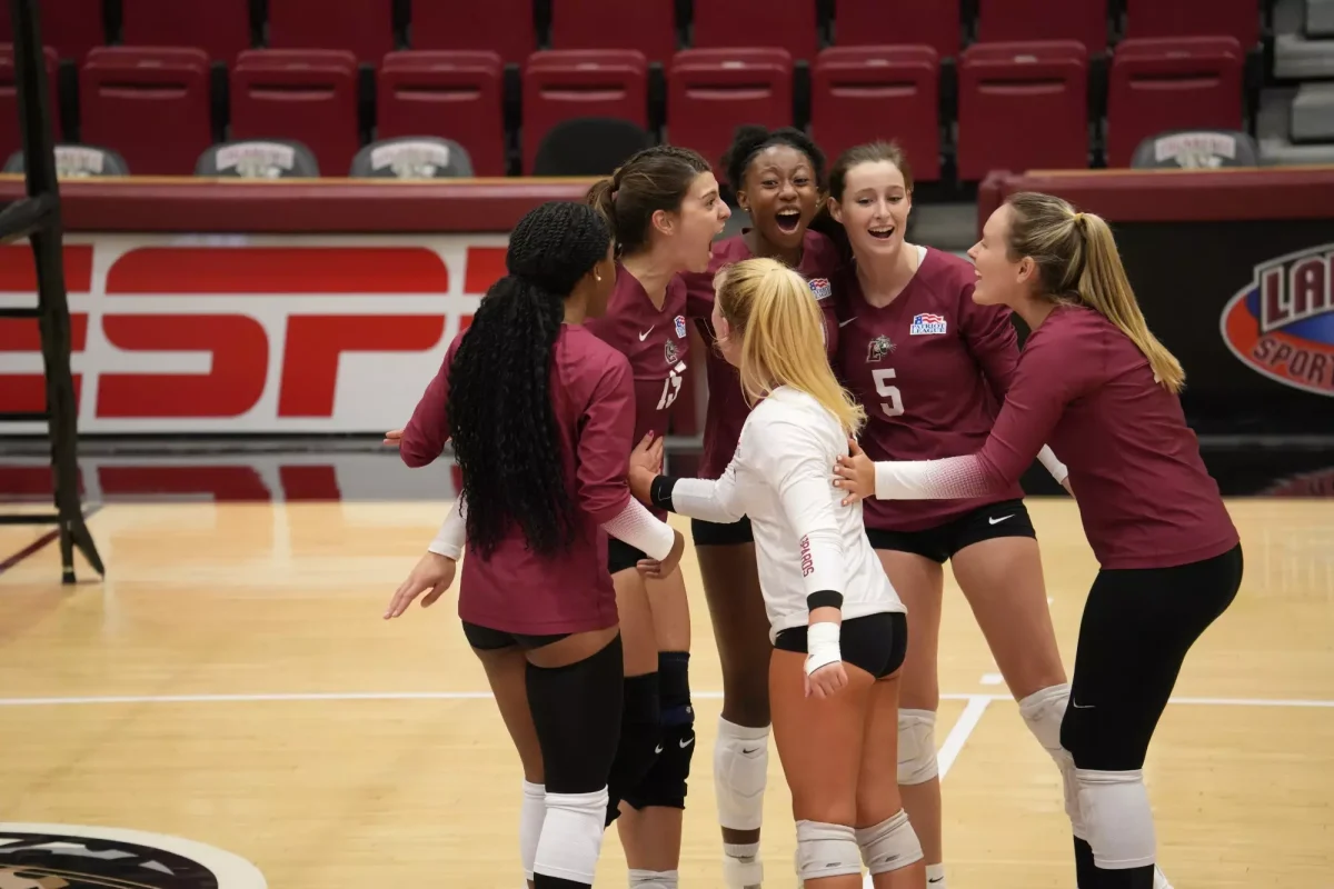 Junior middle blocker Hannah Ehrich-Pollock celebrates with her teammates after a point. (Photo courtesy of GoLeopards)