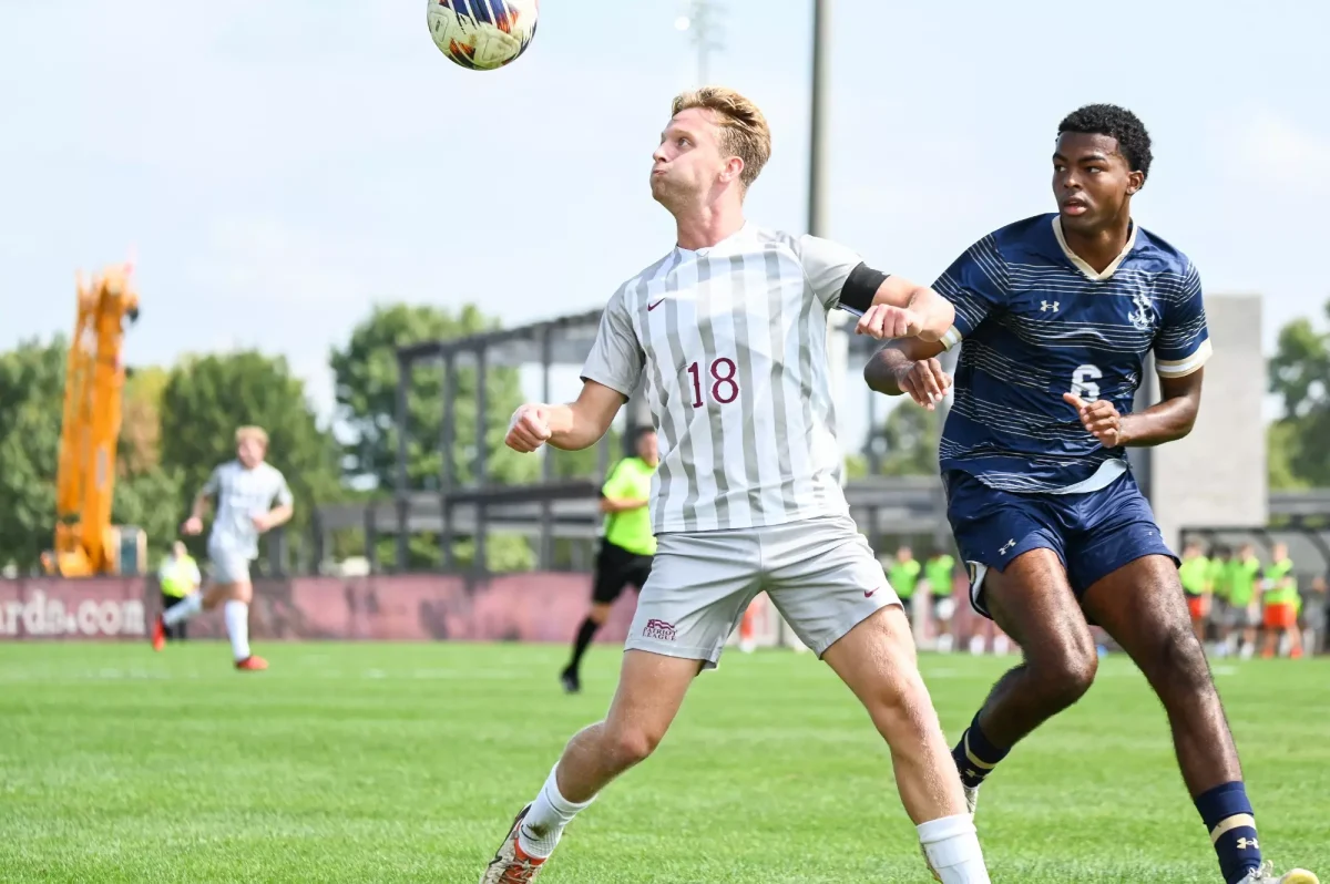 Senior midfielder Carter Houlihan readies for a header in the Leopards' Sept. 21 matchup against Navy. (Photo by George Varkanis for GoLeopards)