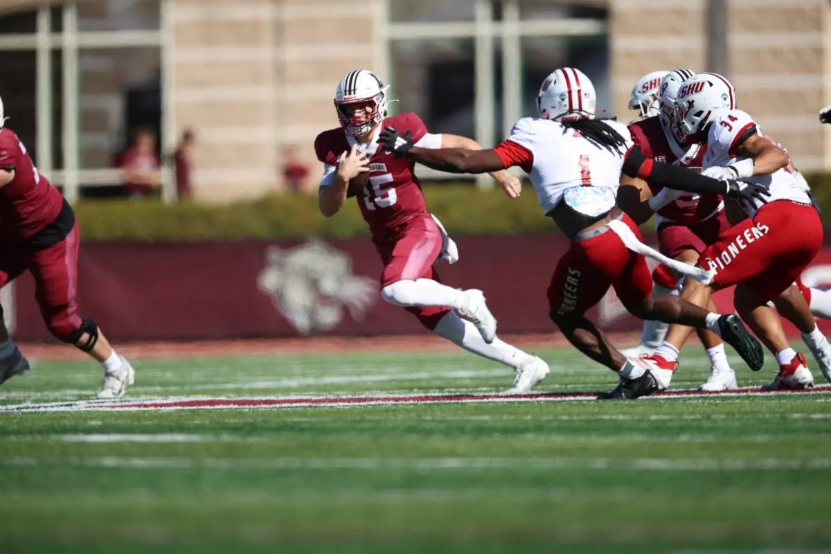 Freshman quarterback Jason Penza looks to evade a defender against Sacred Heart University last Saturday. (Photo by Rick Smith for GoLeopards)