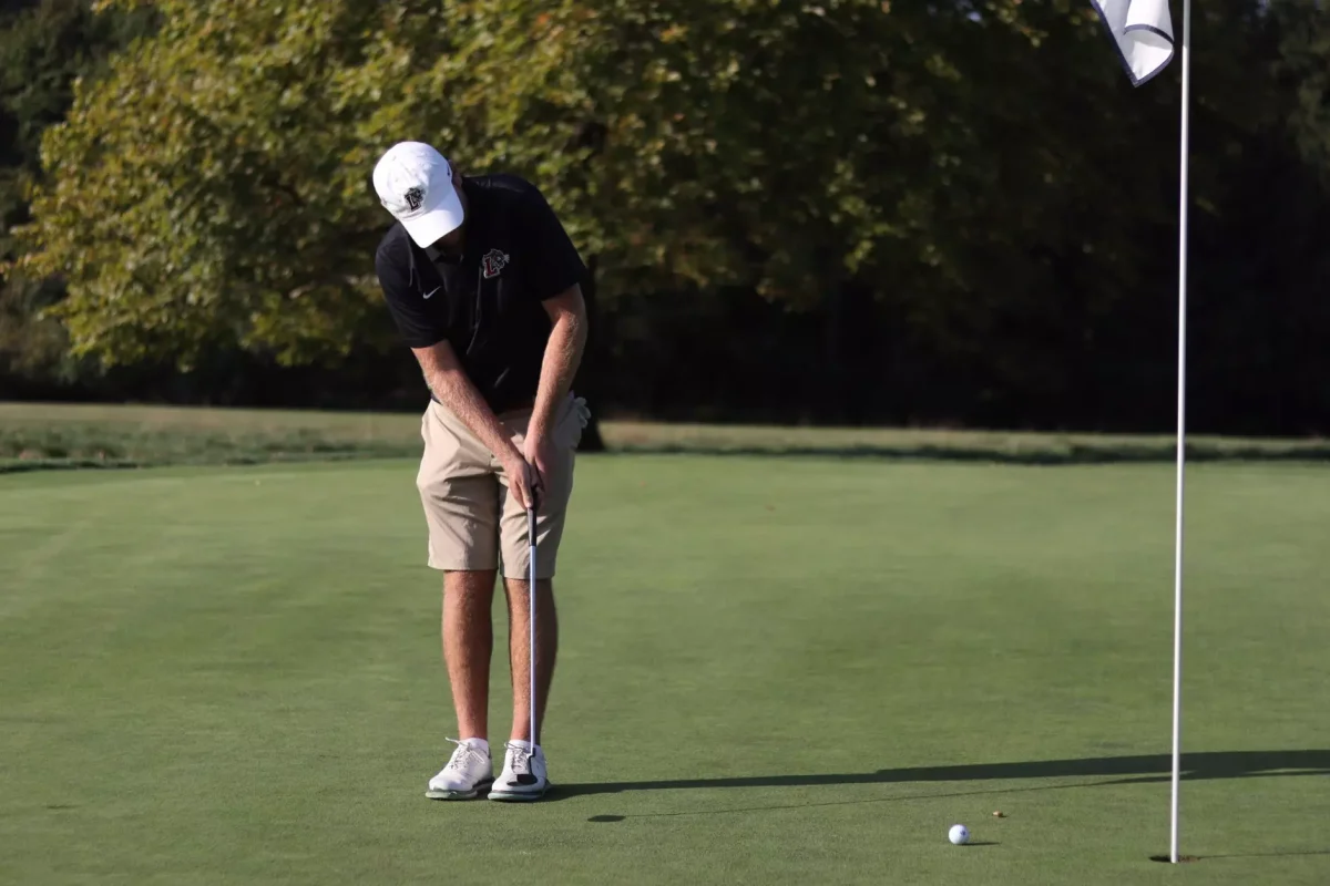 Junior Harry Dessel taps in a putt at the Bucknell Golf Club. (Photo courtesy of GoLeopards)